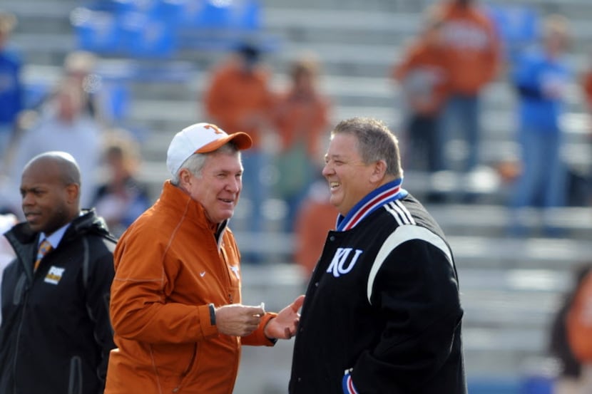 Oct 27, 2012; Lawrence, KS, USA; Texas Longhorns head coach Mack Brown (left) talks to...