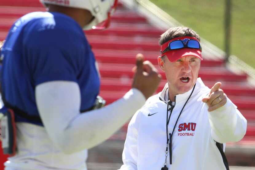 Chad Morris, the new head coach for the SMU Mustangs football team, directs his players...