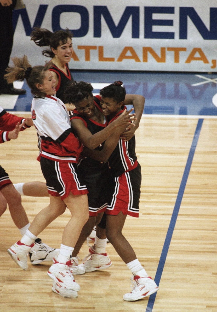 FILE - Texas Tech players run onto the court to hug star Sheryl Swoopes (right), who scored...