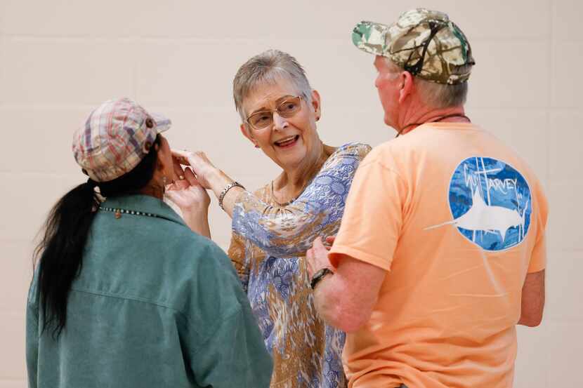 Douglassville resident Charleen Granberry, center, talks to other residents during a...