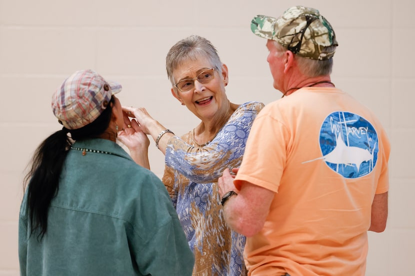 Douglassville resident Charleen Granberry, center, talks to other residents during a...