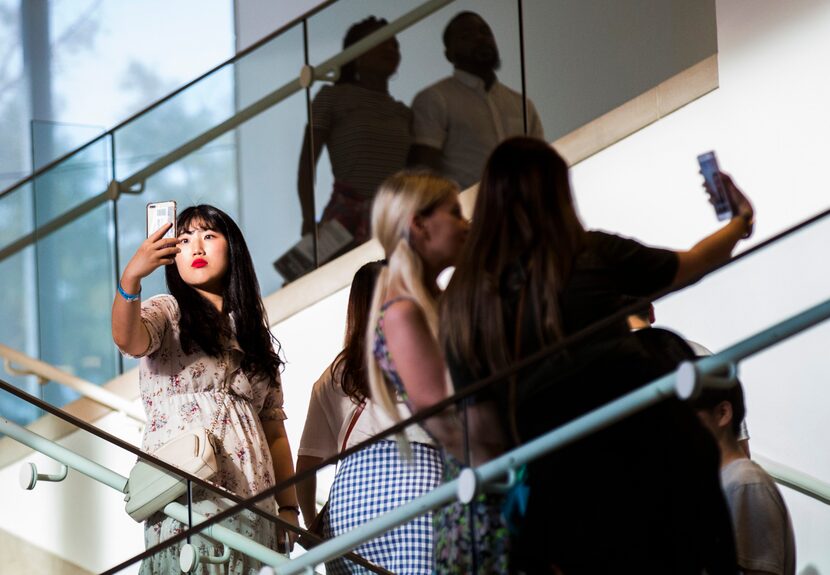 Patrons take selfies during the Dallas Museum of Art's monthly Late Night program on July...