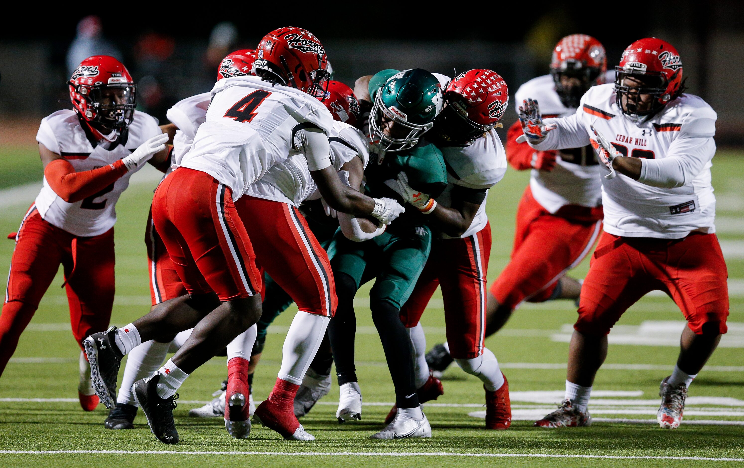 Waxahachie senior wide receiver Brandon Hawkins Jr., third from right, is tackled by several...