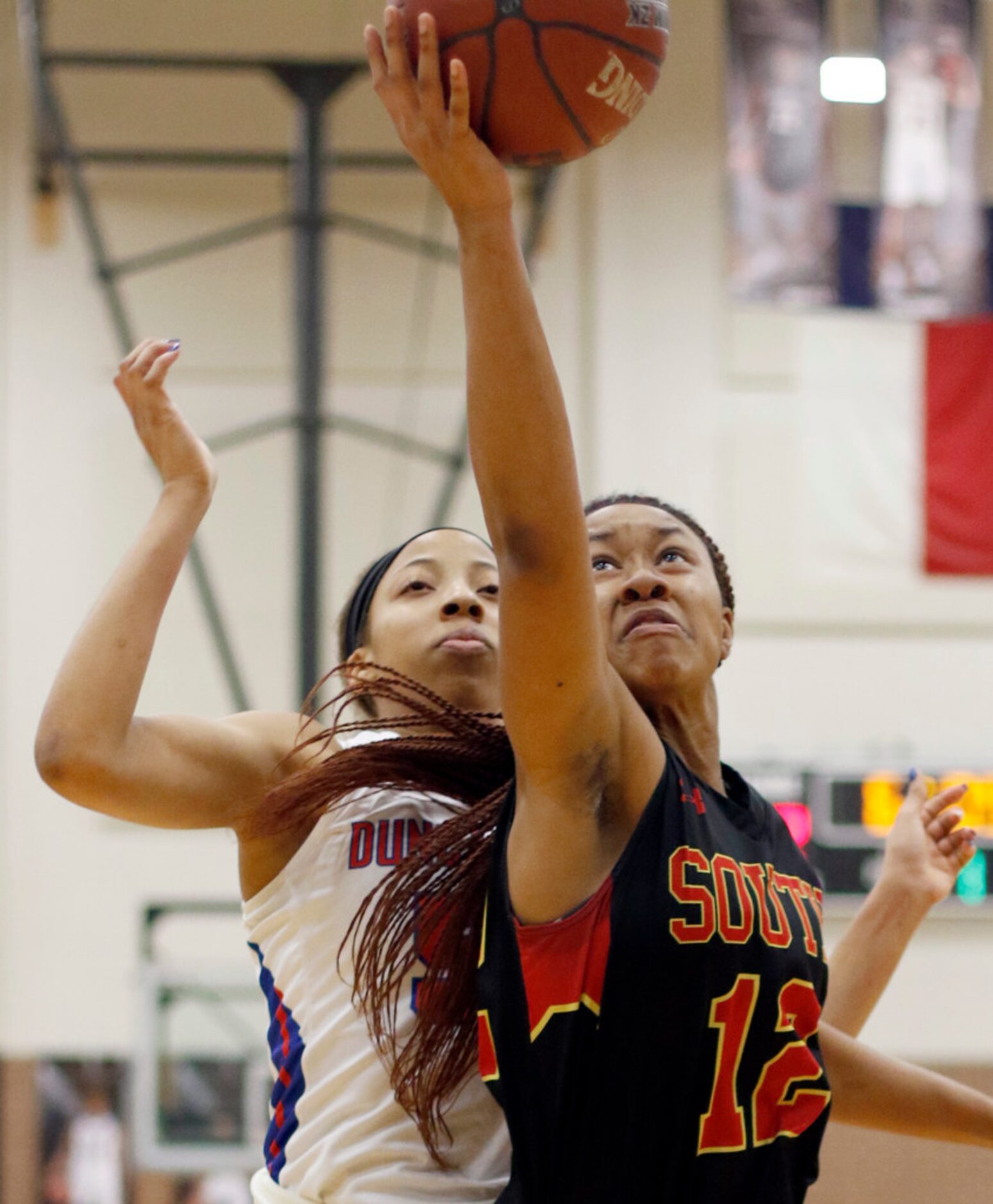 South Grand Prairie forward Camryn Hill (12) reaches over Duncanville post Zaria Rufus (50)...