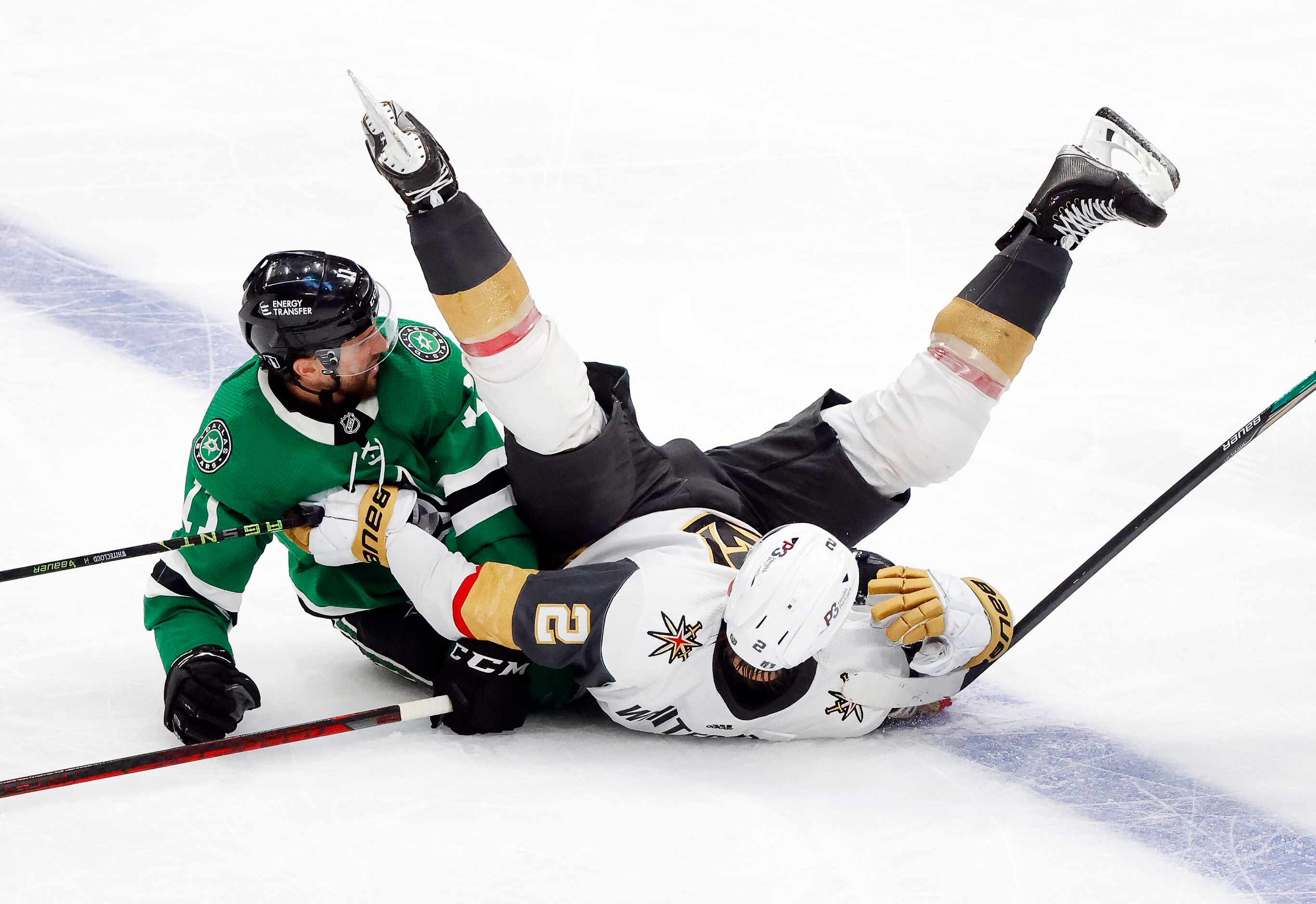 Vegas Golden Knights defenseman Zach Whitecloud (2) falls on the puck after going down with...