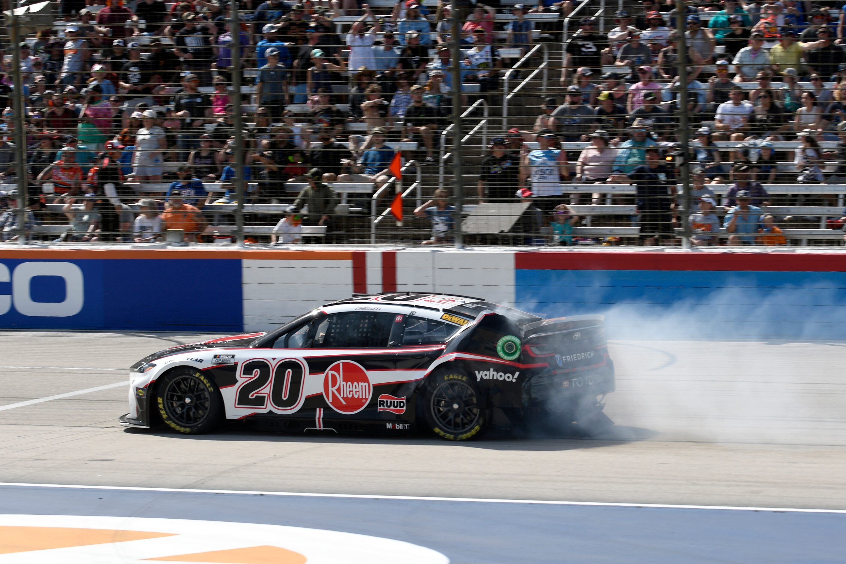 Smoke blows from the rear of Christopher Bell's (20) car after crashing coming out of Turn 4...