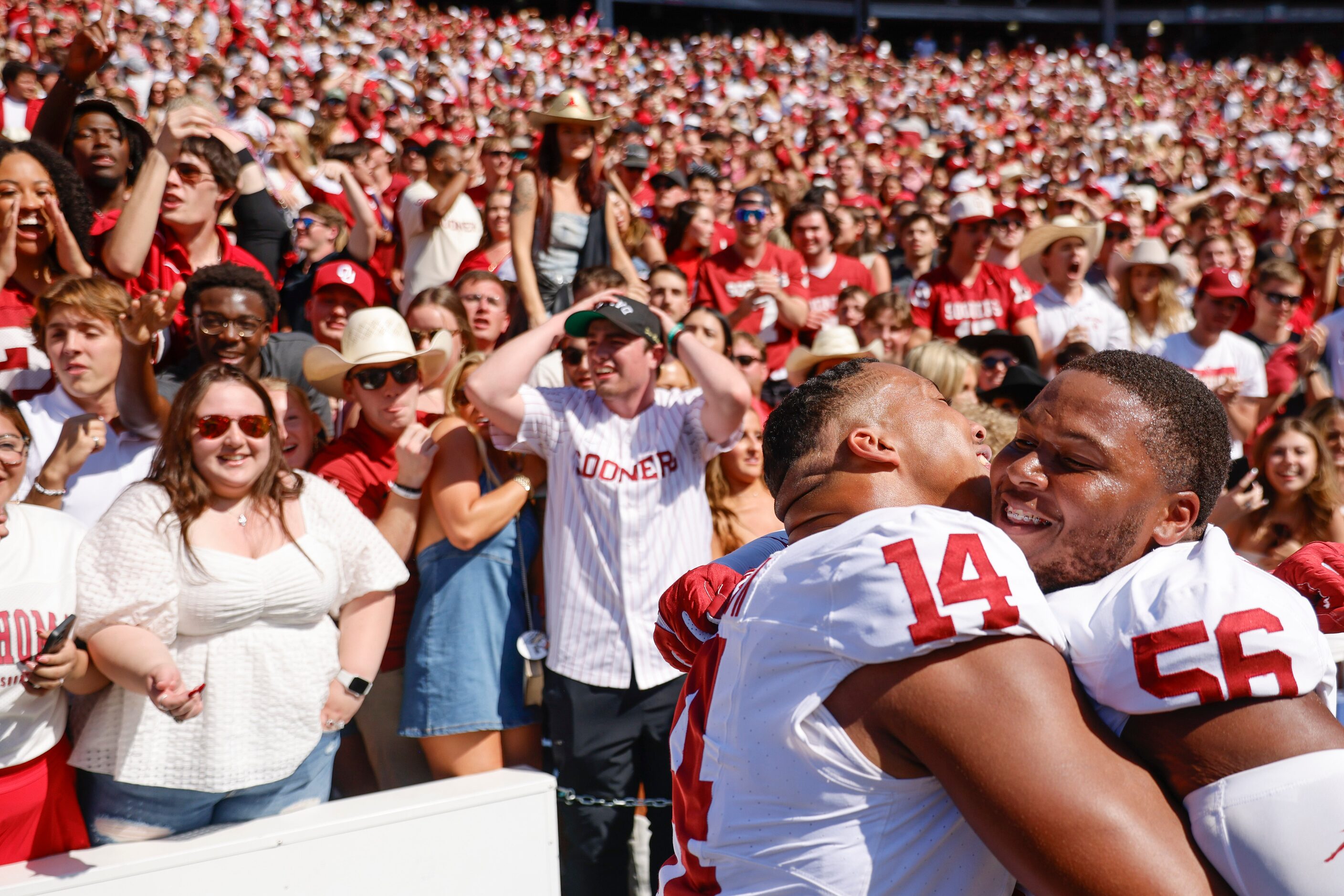 Oklahoma defensive lineman Reggie Grimes II (left) embraces defensive lineman Gracen Halton...