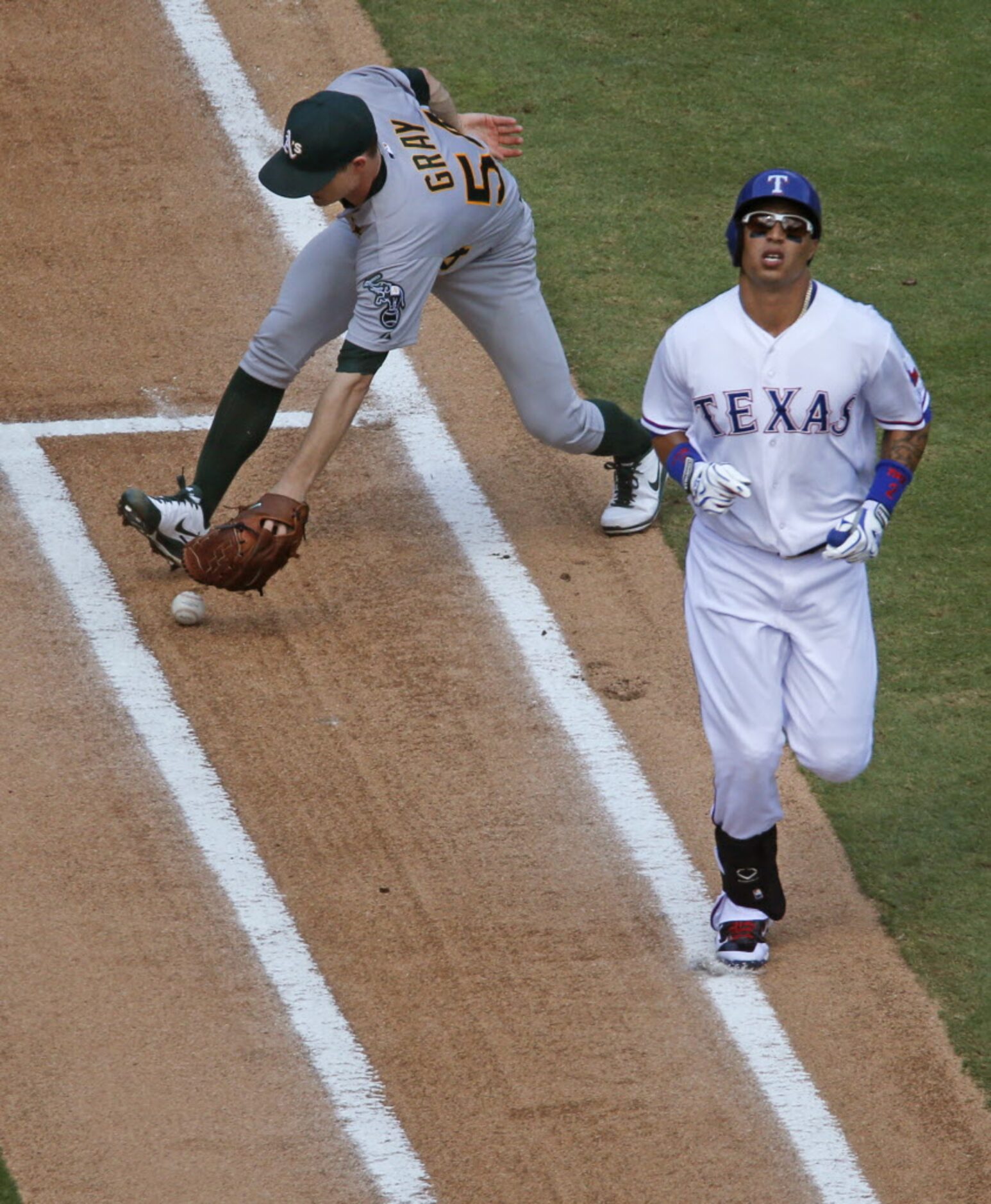 Texas leadoff hitter Leonys Martin motors down the first base line as Oakland pitcher Sonny...