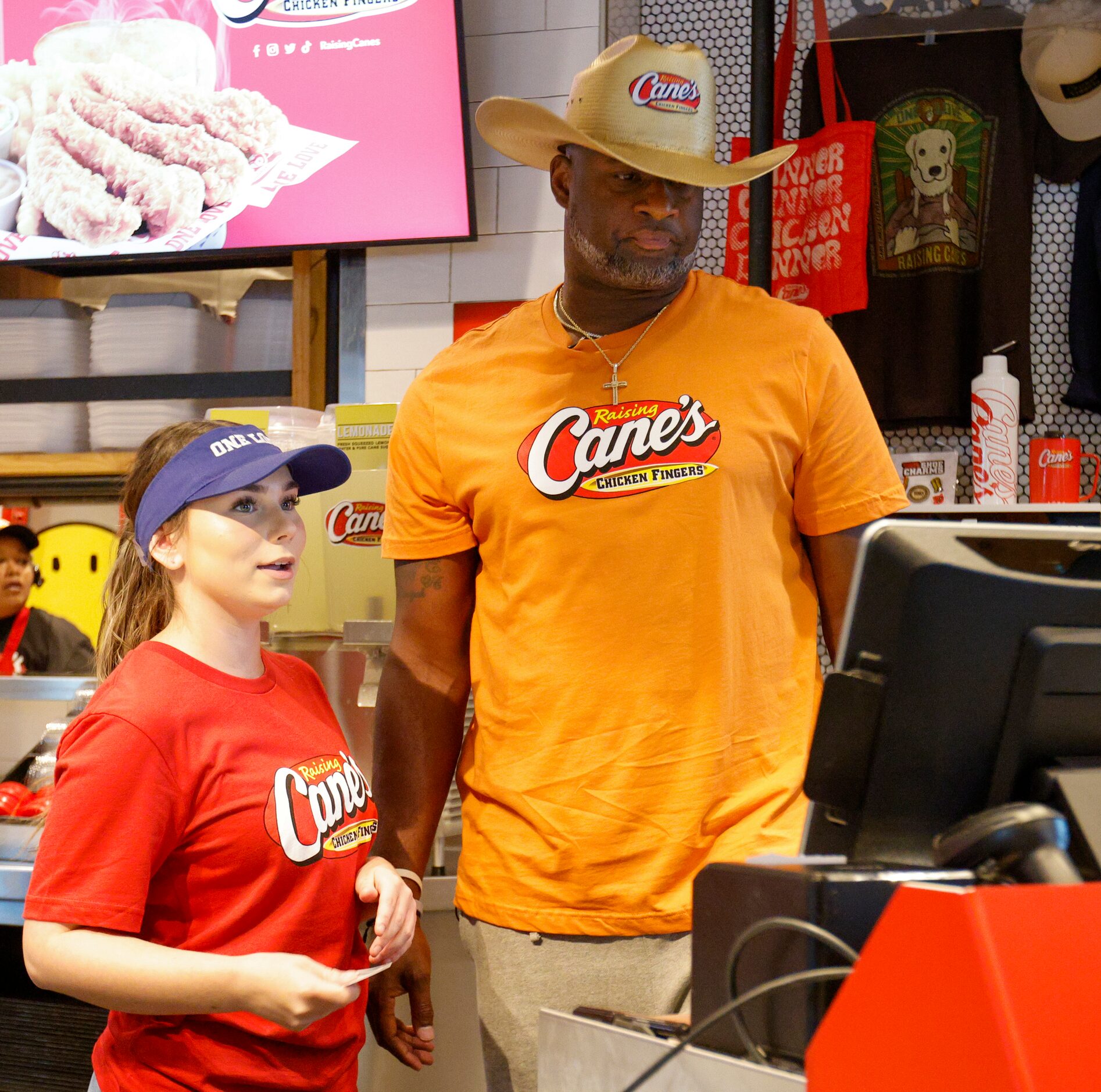 Raising Cane’s employee Makayla Garza quickly trains former Texas quarterback Vince Young...