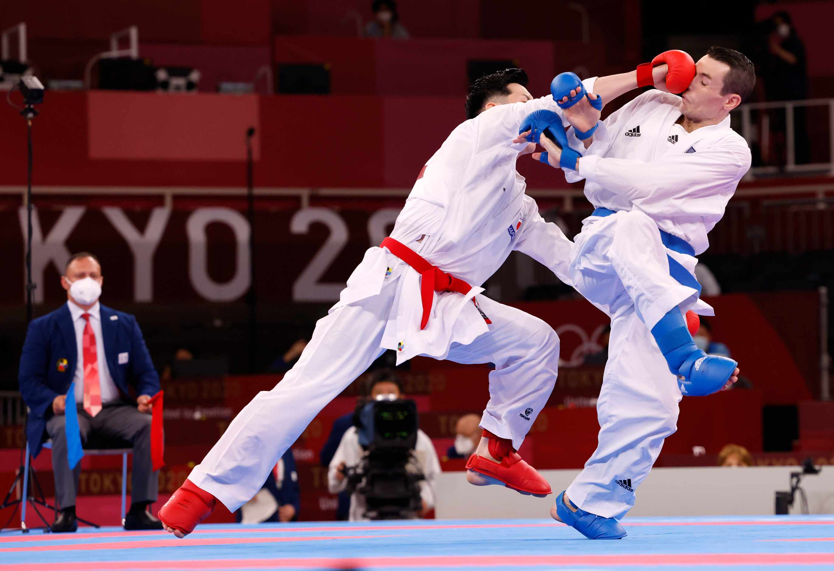 USA’s Tom Scott is hit in the face by Japan’s Ken Nishimura during the karate men’s kumite...