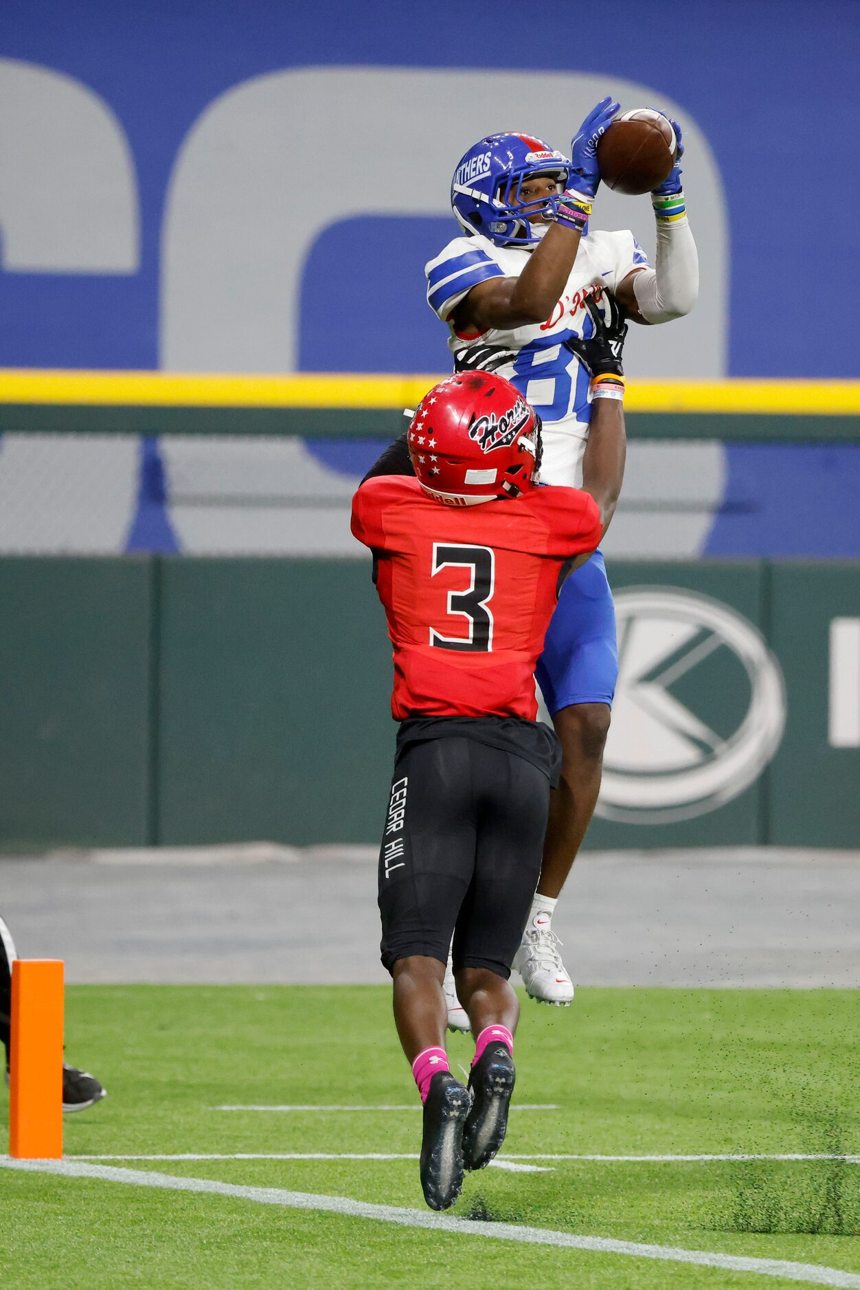 Duncanville receiver Dakorien Moore (80) catches a touchdown in front of Cedar Hill defender...