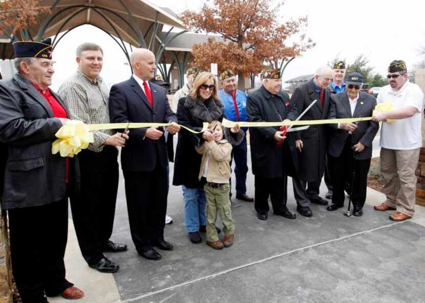 
Luke Bush and his mother, Mary Bush, make the first ribbon cut for the expansion of the...