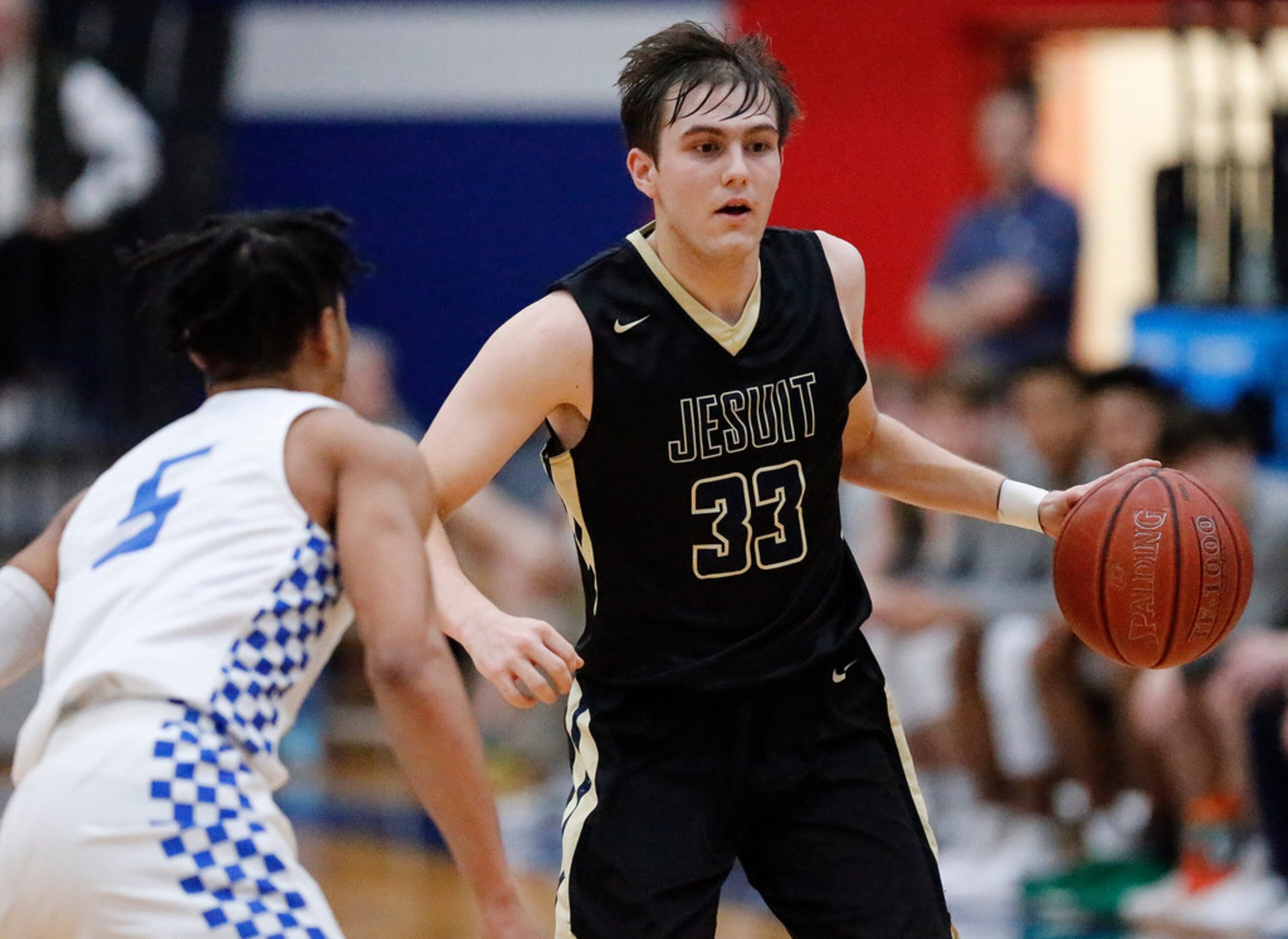 Dallas Jesuit guard Gavin Perryman (33) handles the ball while South Garland High School...