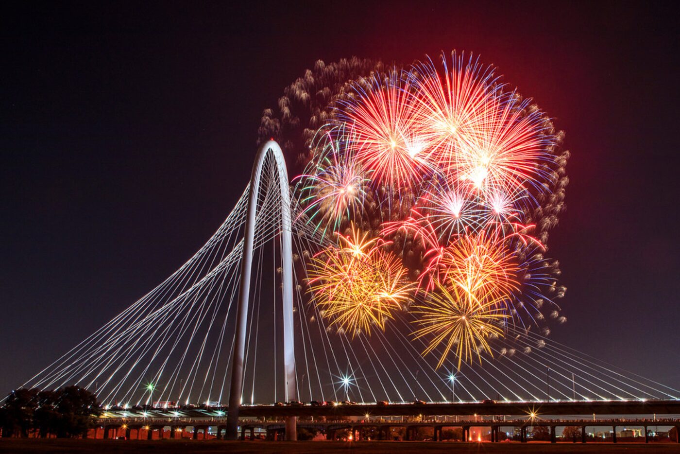 Fireworks explode over the Margaret Hunt Hill Bridge during the Red, White, and Boom on the...