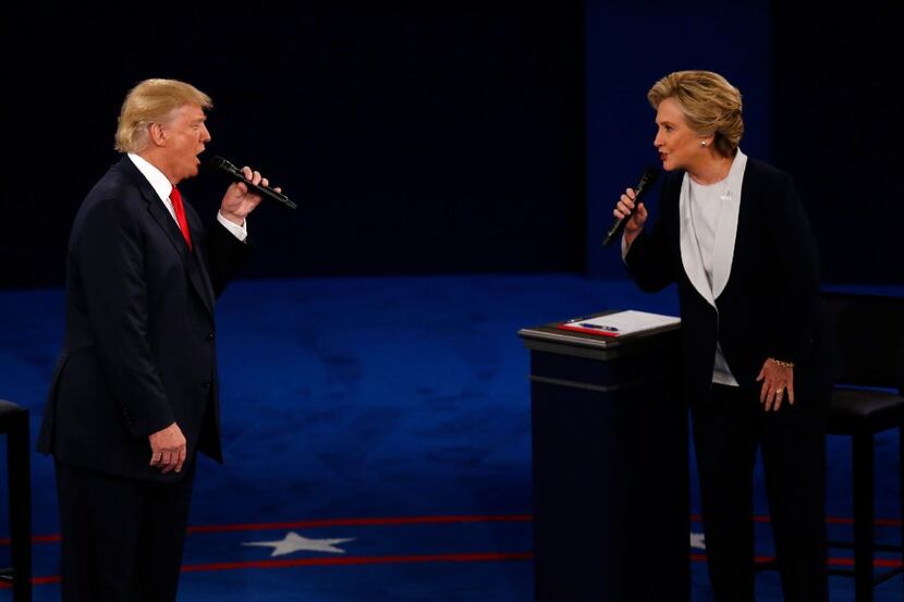 Donald Trump and Hillary Clinton spar at the presidential debate at Washington University in...