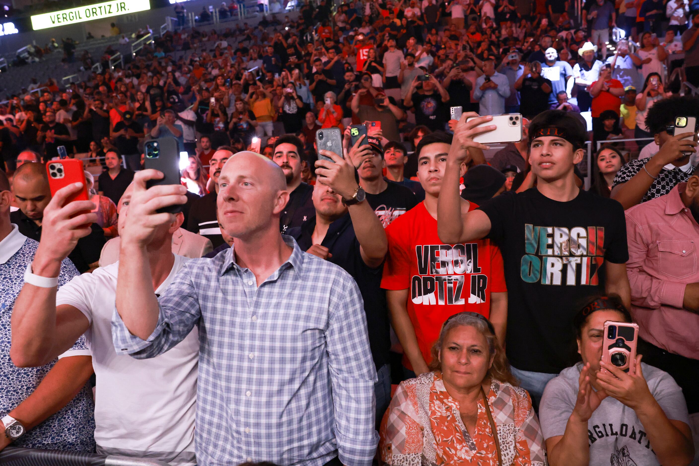 Fans hold their phones up as Vergil Oritz Jr. walks into the ring Saturday, August 6, 2022,...