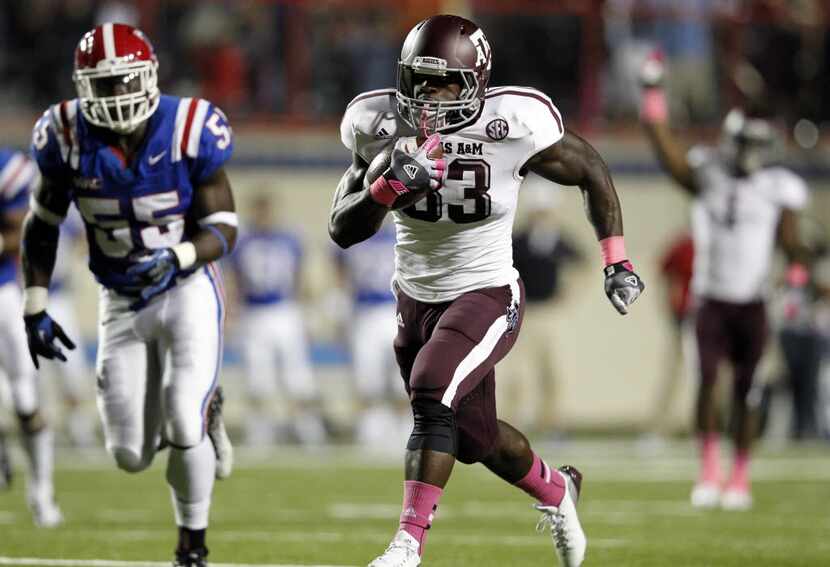 Texas A&M Aggies running back Christine Michael (33) runs through the Louisiana Tech...