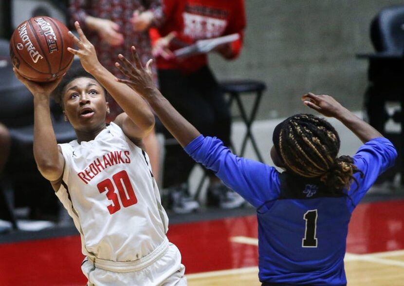 Frisco Liberty's Jazzy Owens-Barnett (30) puts up a shot past Kaylin Smith (1) during the...