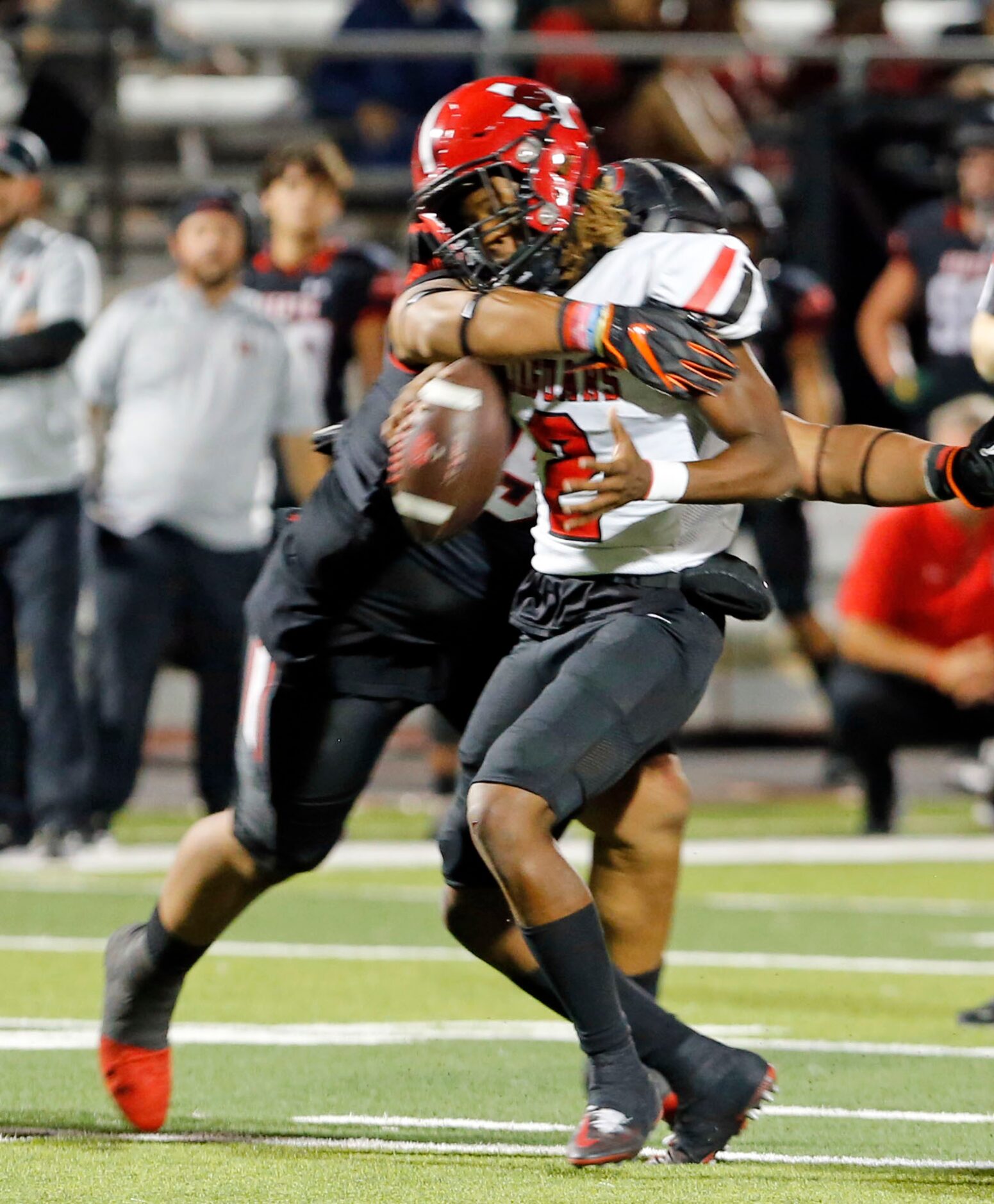 Mesquite Horn QB J.T. Thomas (2) is hit hard by a Rockwall Heath defender during the first...