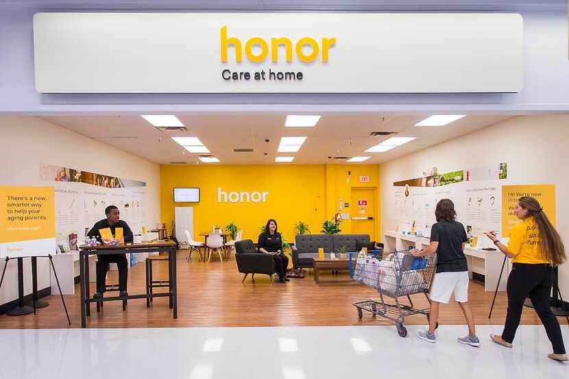 Employees at Honor address a shopper as the home-health provider opens one of its first...