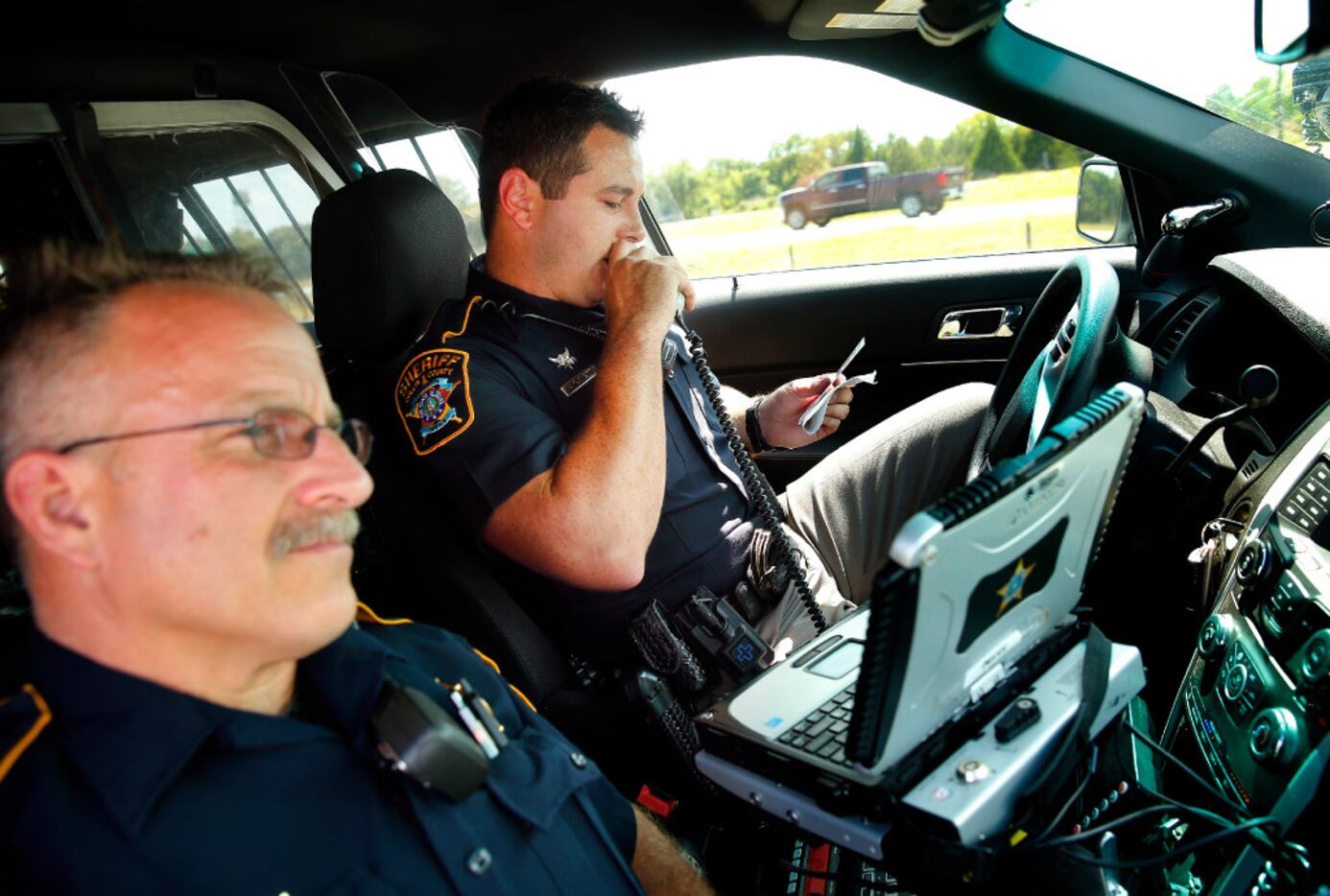 Collin County Sheriff's deputies Rodney Tackett (right) and Kelly Reynolds check a driver's...