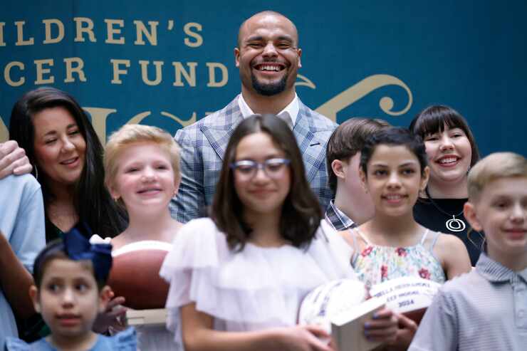 Dallas Cowboys Dak Prescott does for a photo with pediatric patient models for the upcoming...