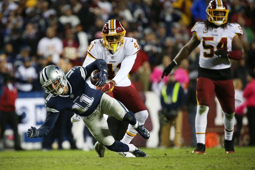 Dallas Cowboys wide receiver Cole Beasley (11) is tackled by Washington Redskins defensive...