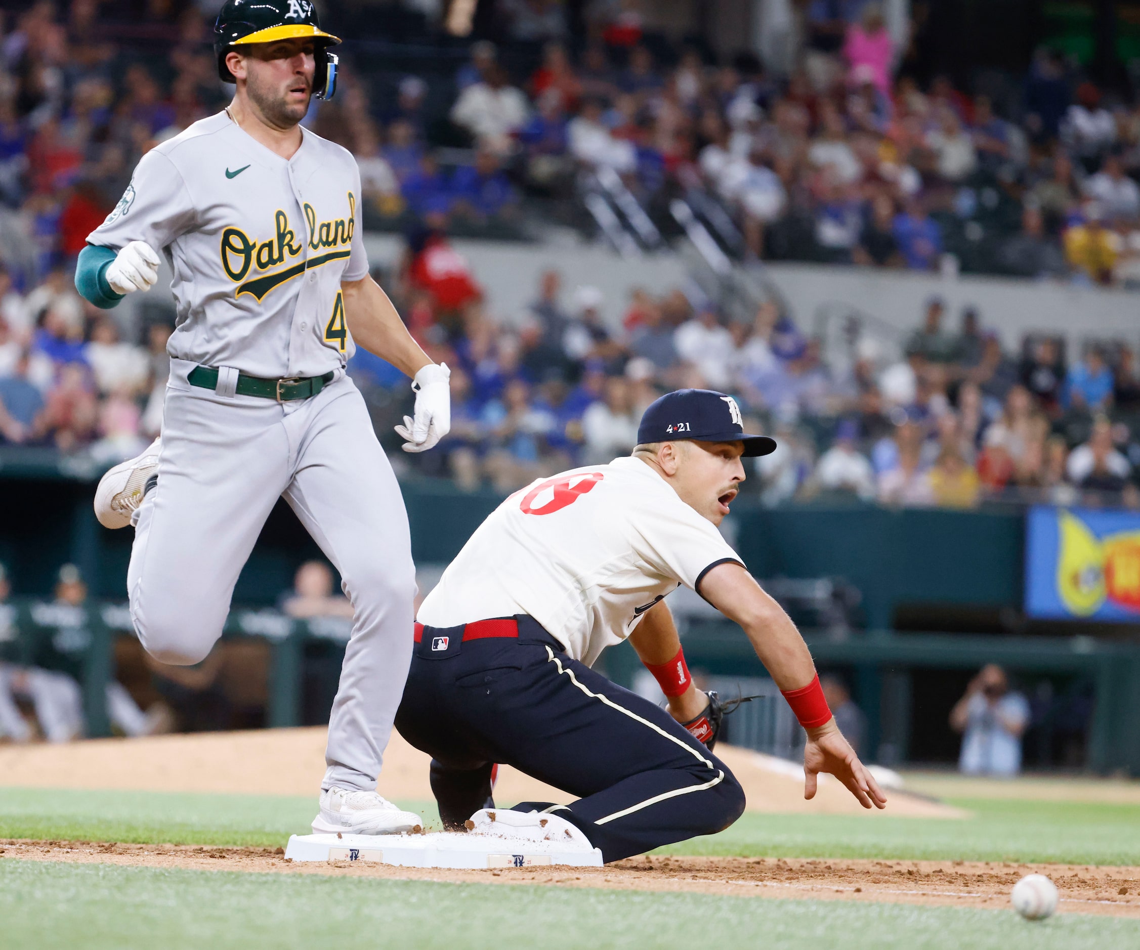 Oakland Athletics first baseman Ryan Noda safely reach the first base as Texas Rangers first...