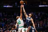 Boston Celtics center Al Horford (42) and Dallas Mavericks center Dereck Lively II (2) reach...