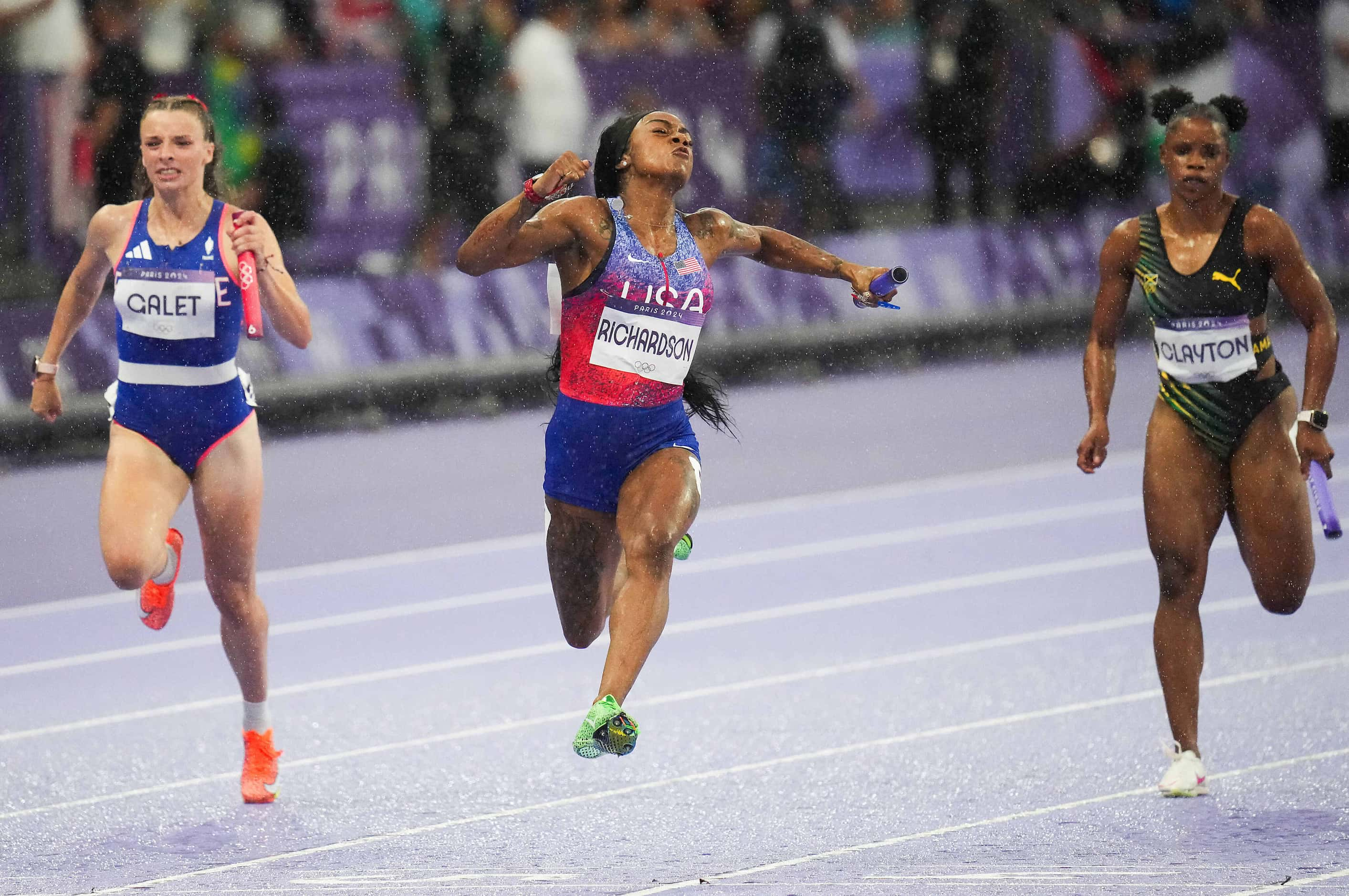 Sha'carri Richardson of the United States crosses the finish line to win the women's 4 x 100...