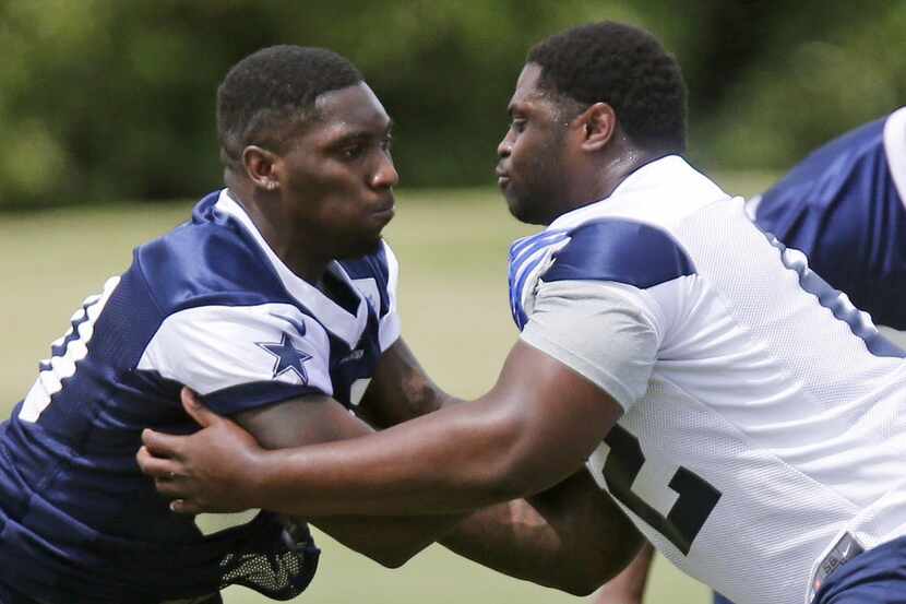 Dallas Cowboys defensive end DeMarcus Lawrence (left) is pictured as Josh Aladenoya (62)...