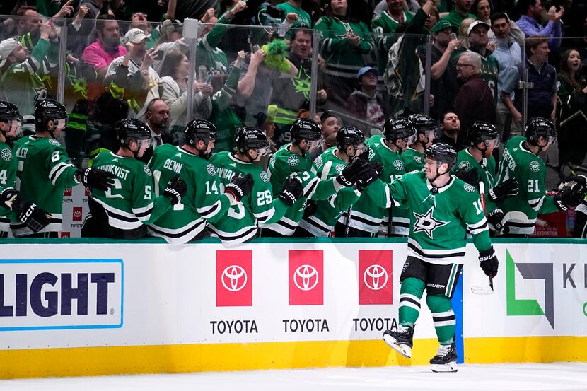 Dallas Stars' Max Domi, front right, celebrates with the bench after scoring in the second...