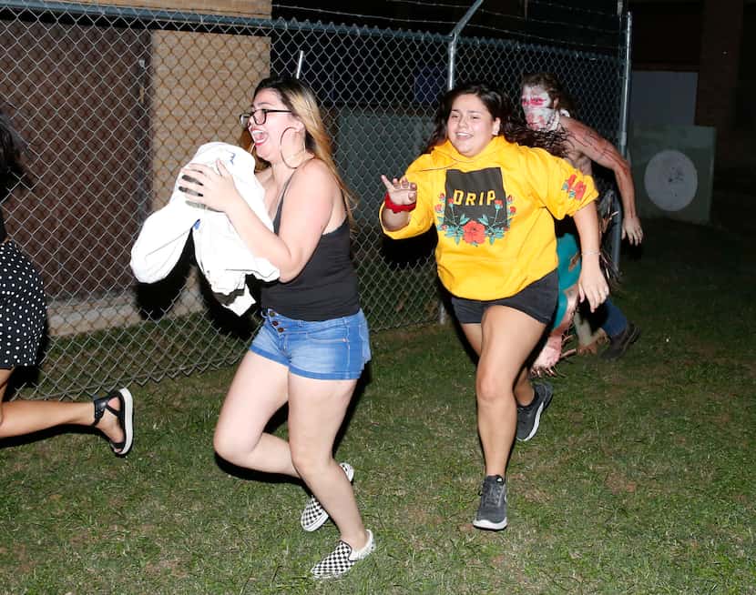 Jessie Reyes (left), Hannah Reyes (center) run from Marshal McKelvy (right) "Tex," as they...