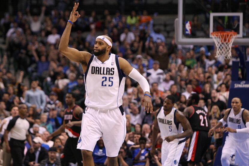 Dallas Mavericks shooting guard Vince Carter (25) reacts to making a three-pointer against...