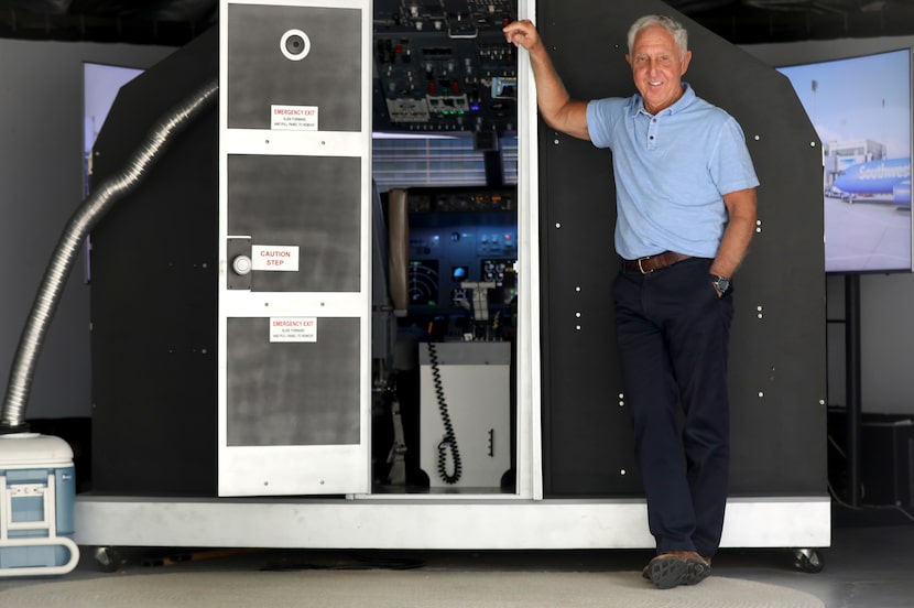 Kevin Sayre poses outside of his flight simulator he built in his garage, at his home in...