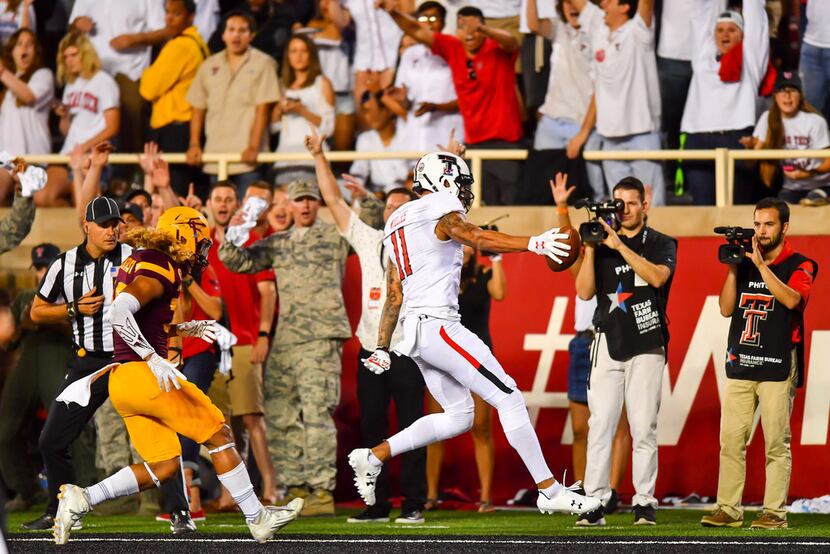 LUBBOCK, TX - SEPTEMBER 16: Derrick Willies #11 of the Texas Tech Red Raiders scores a...