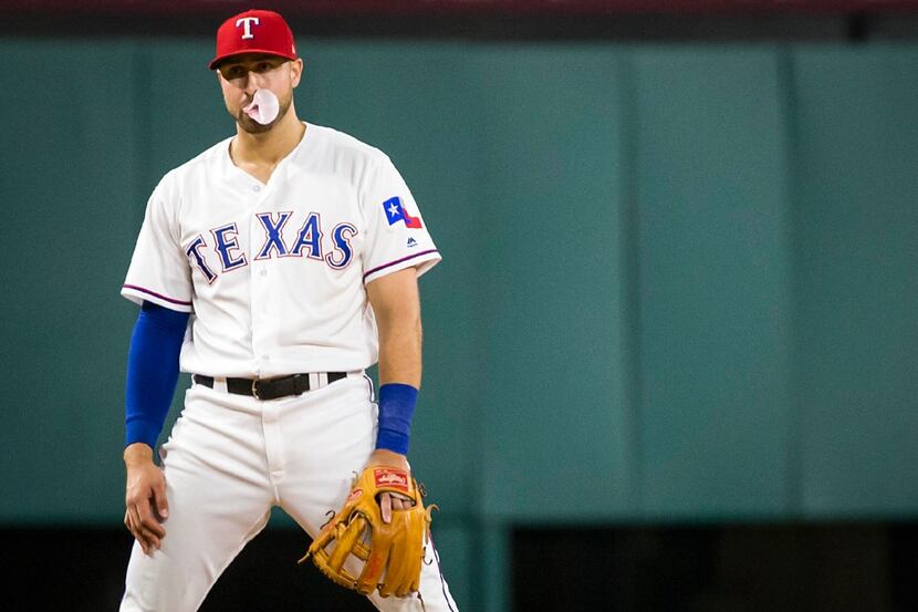 Texas Rangers third baseman Joey Gallo blows bubbles between pitches during the seventh...
