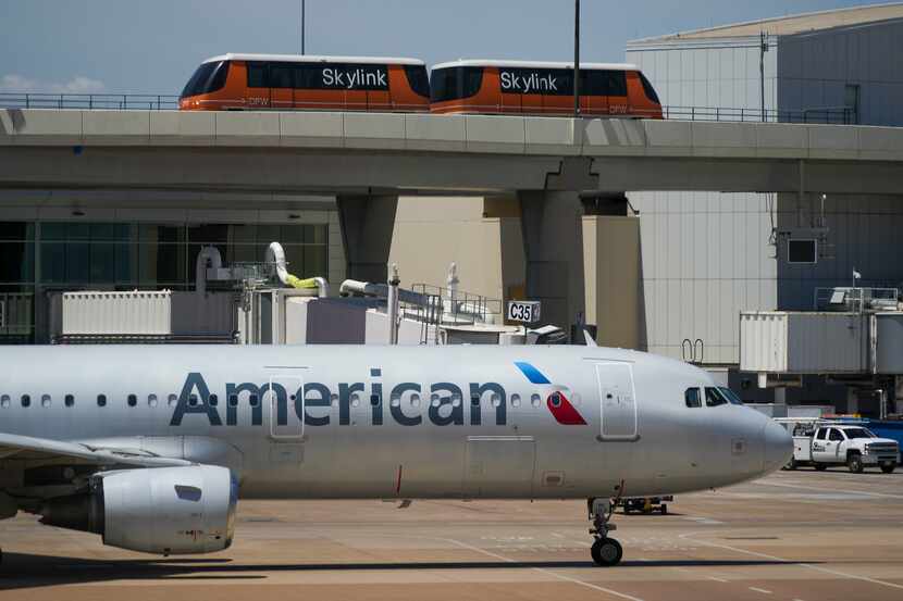 American Airlines planes are seen at the gates of Terminal C at DFW Airport on Saturday,...
