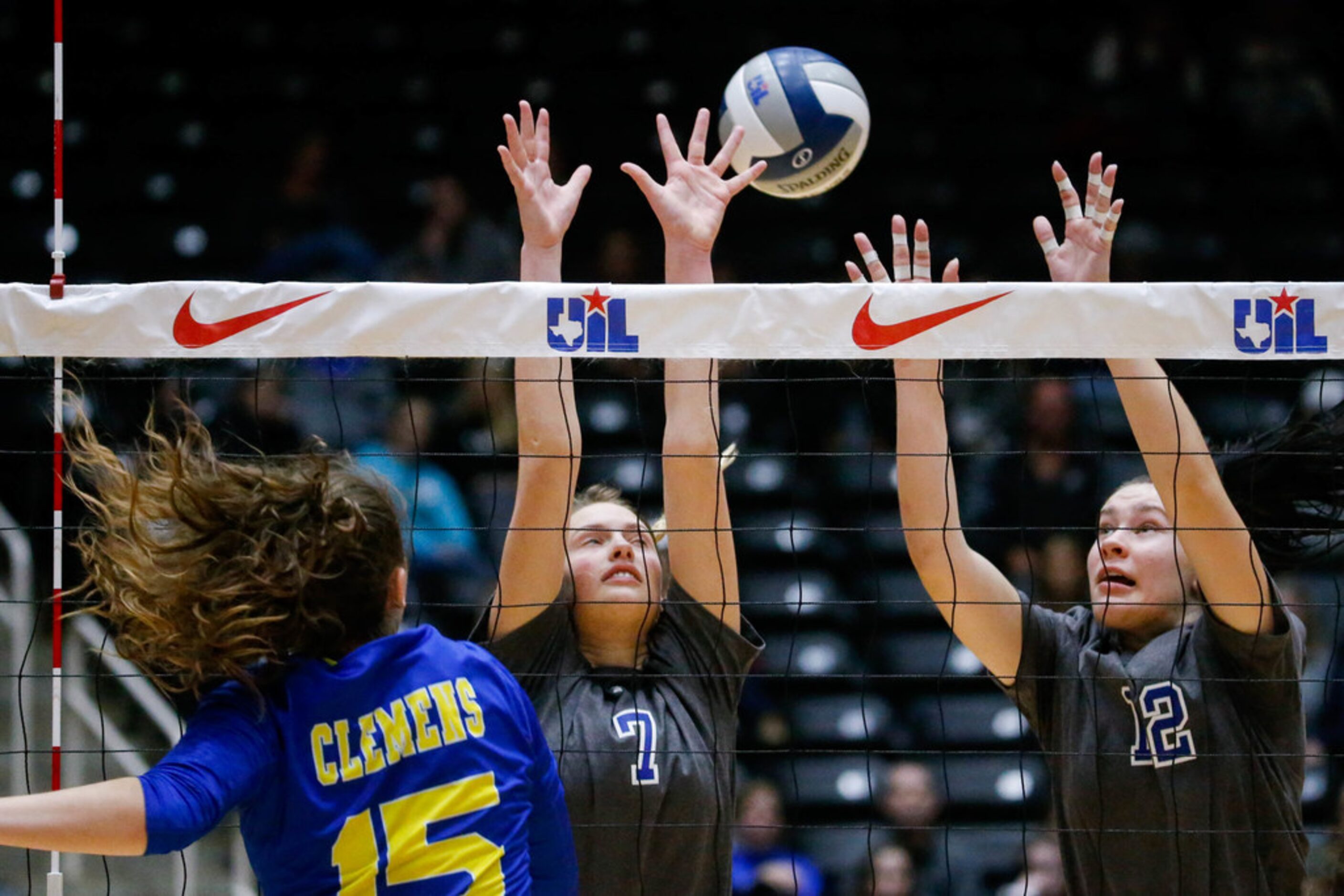 Byron Nelson's Nina Petersen (7) and Payton Chamberlain (12) attempt to block Schertz...