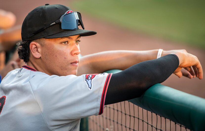 Hickory Crawdad's Dustin Harris (9) watches the game with the Greensboro Grasshoppers from...