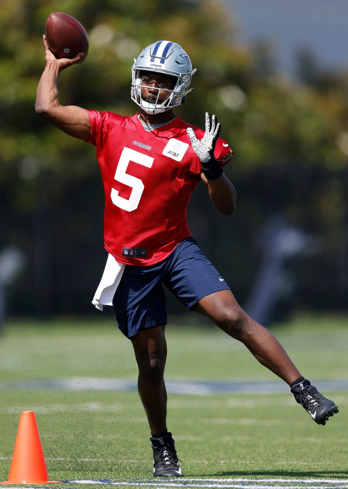 Dallas Cowboys quarterback JT Barrett (5) throws on the run during rookie minicamp at the...