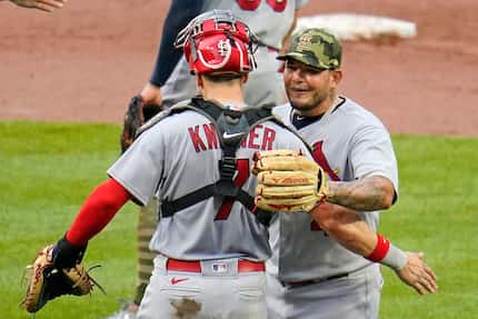 St. Louis Cardinals relief pitcher Yadier Molina, right, celebrates with catcher Andrew...