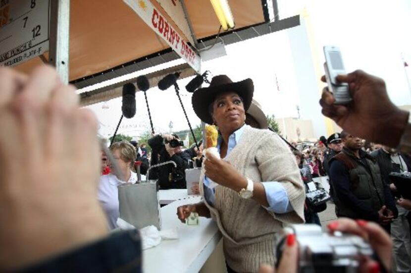 Oprah Winfrey eats a corny dog with mustard at the State Fair of Texas in  2009. 