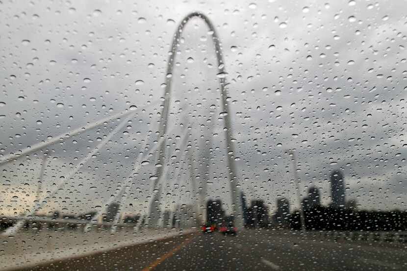 Margaret Hunt Hill Bridge seen through raindrops on a windshield in Dallas on Monday, July...