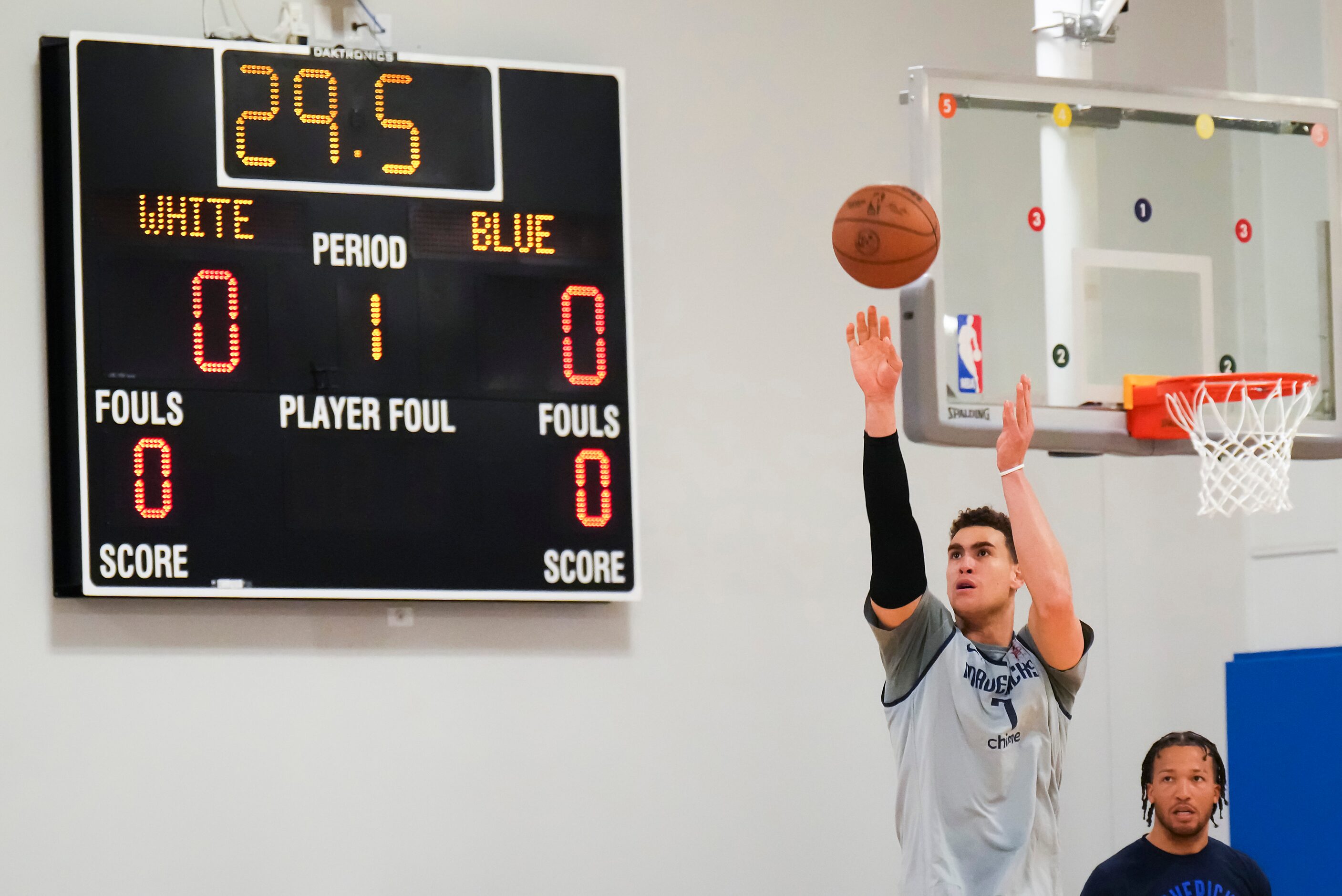 Dallas Mavericks center Dwight Powell (7) shoots while guard Jalen Brunson looks on as the...