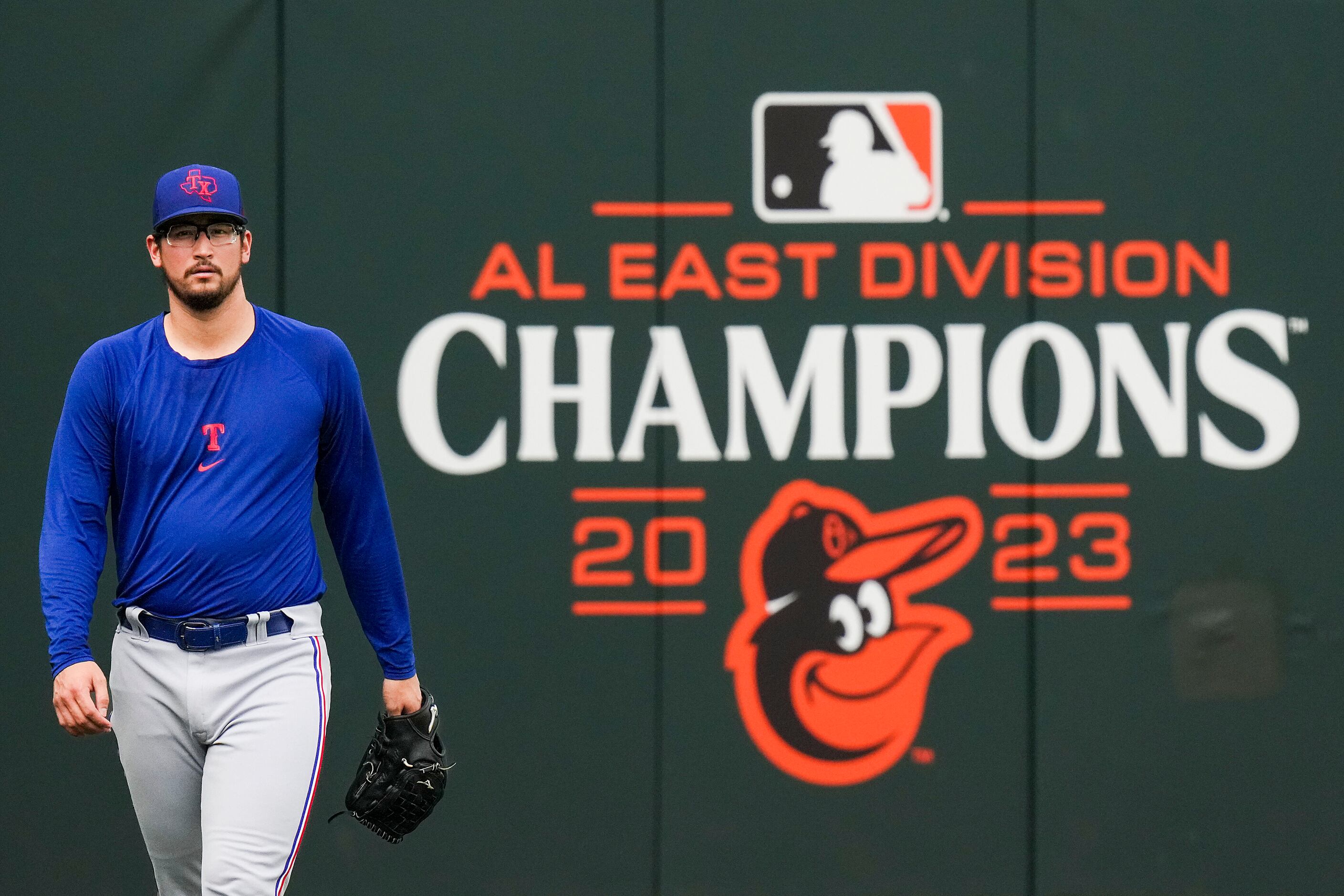 Dogs dressed as New York Mets players walk the warning track for