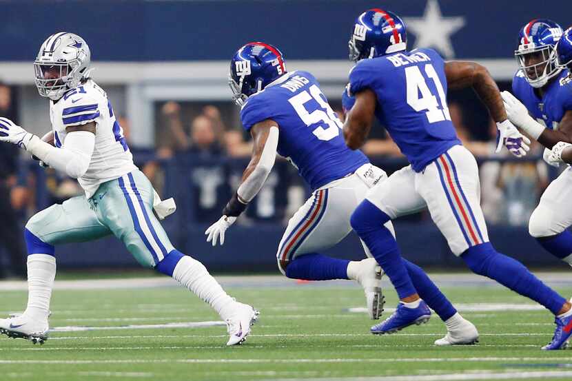 Dallas Cowboys running back Ezekiel Elliott (21) rushes up the field as New York Giants...