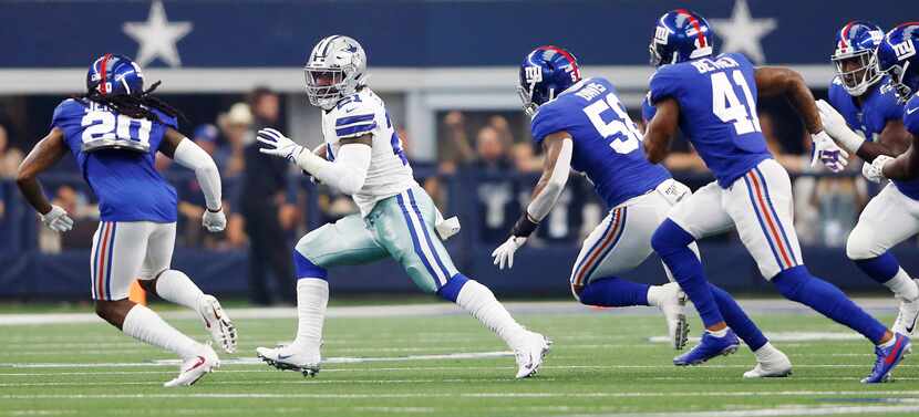 Dallas Cowboys running back Ezekiel Elliott (21) rushes up the field in the home opener...