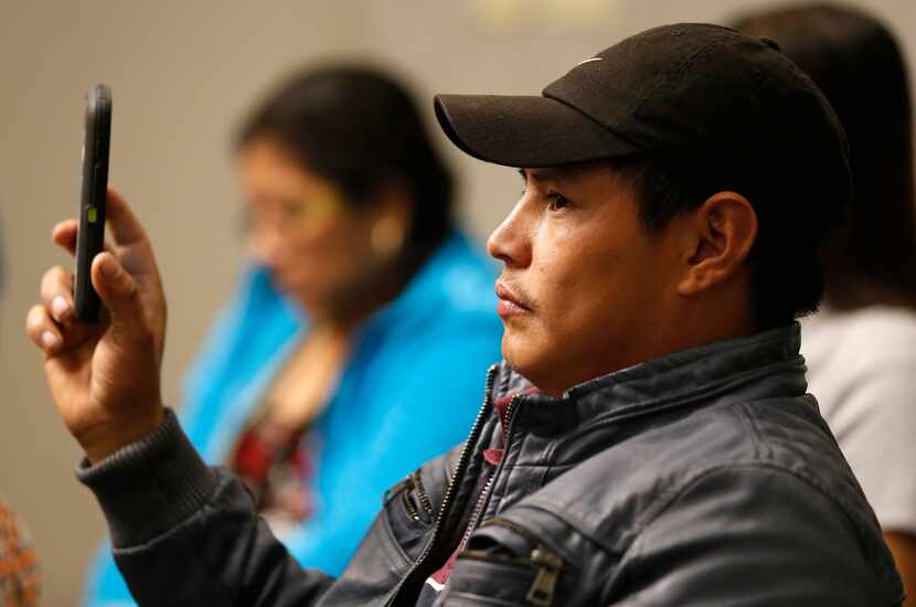 Misael Nunez records video of immigration attorney Paul Zoltan speaking at an immigration...