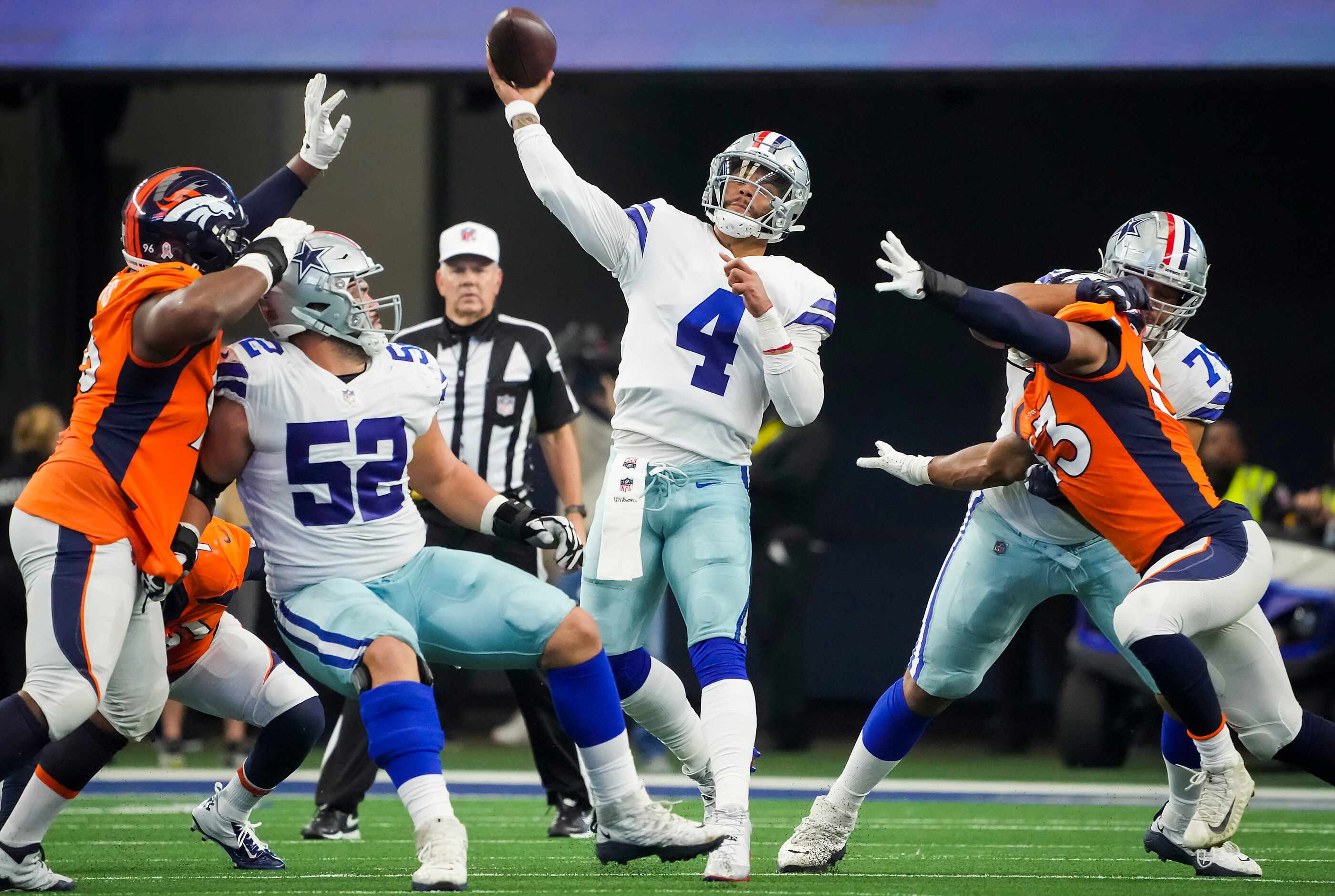 Dallas Cowboys quarterback Dak Prescott (4) throws a pass as guard Connor Williams (52) and...